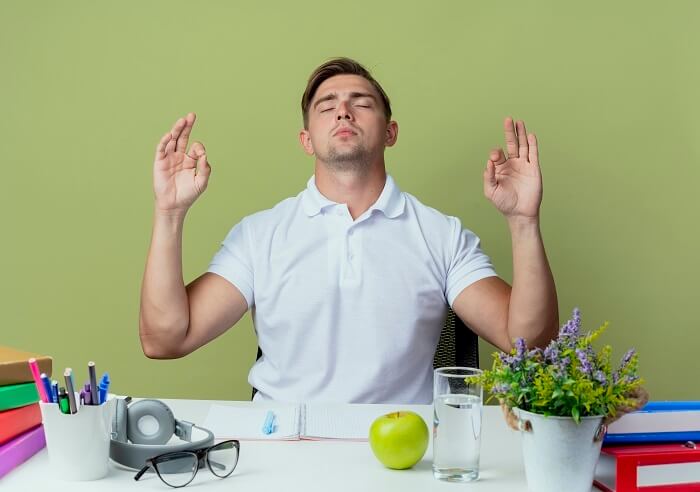 A person sitting in a peaceful setting, surrounded by calming elements, highlighting the idea that managing stress becomes easier when exhaustion is acknowledged and addressed.